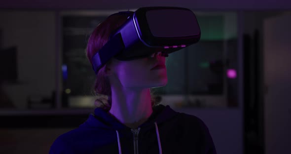 Caucasian woman wearing VR headset in creative office