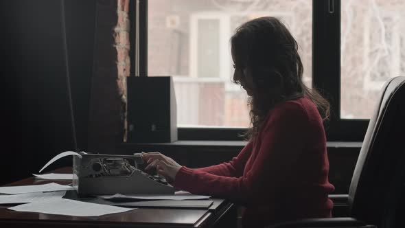 Woman Writer Using Typing Machine to Create Novel