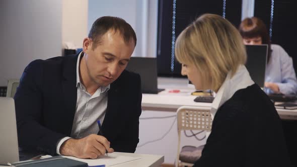 Qualified Man Making Notes and Researching New Startup with Woma