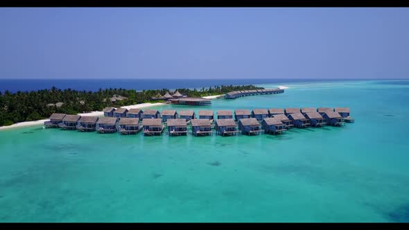 Aerial flying over seascape of exotic seashore beach time by blue ocean with bright sand background 