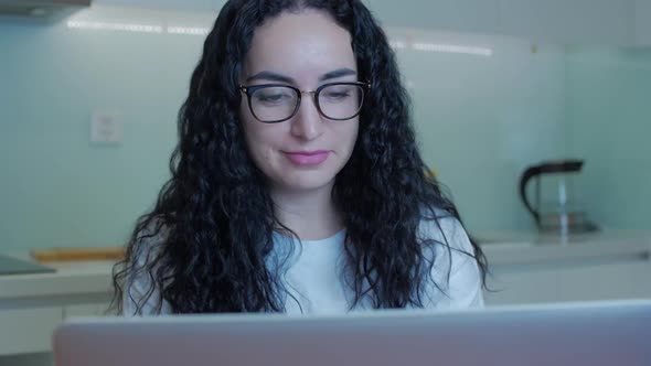 Woman Typing on Laptop Sitting on Sofa at Home, Businesswoman Sits at Home Types on Smartphone