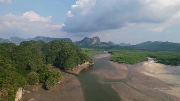 River in Ao Thalane Krabi Thailand revealing many sandbar on a sunny day with limestone mountains an