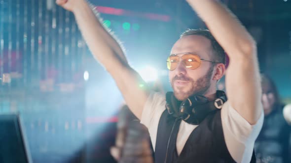 DJ is Playing Music at a Party in a Nightclub