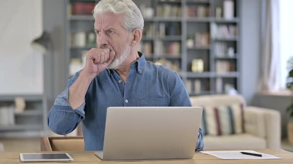 Sick Old Man Coughing in Office