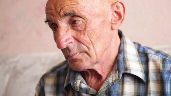 The sad look of an elderly Caucasian man. Senior citizen 70-79 years old serious portrait. The theme