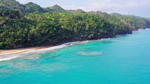 Sweeping Wide Aerial View of Vibrant Turquoise Blue Colours of Ocean Waters off the Dominican Shorel