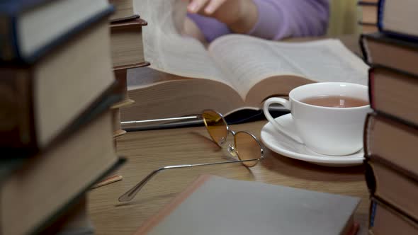 Female Hand Flipping Through the Pages of a Book Closeup