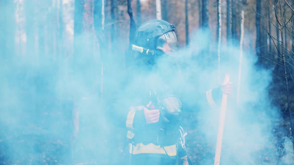 Fireman is Talking Over the Radio in the Smoldering Woods