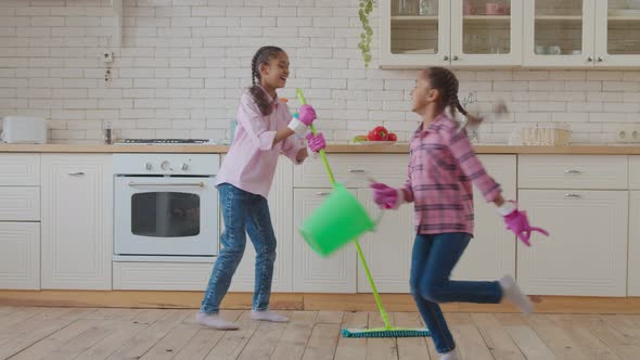 Joyful Mixed Race Kids Having Fun During Cleaning