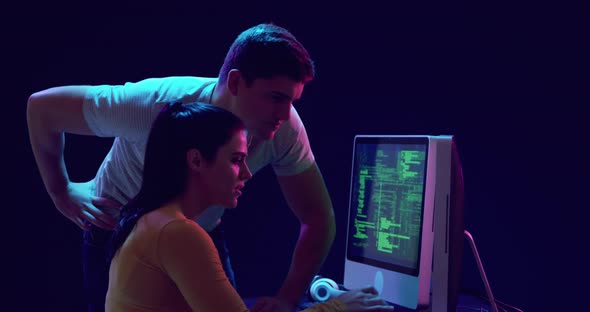 Man and woman working on computers