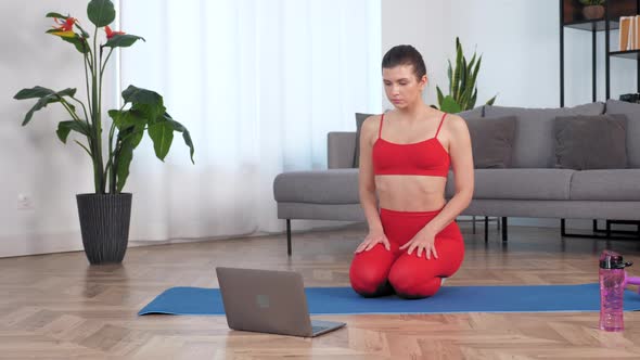 Woman in Sportswear Doing Warmup Before Workout Exercise on Yoga Fitness Mat