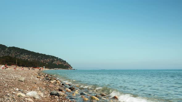 Seashore with pebble beach and turquoise sea 