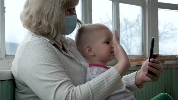 Grandmother And Baby Grandson Video Call To Relatives In Coronavirus Quarantine