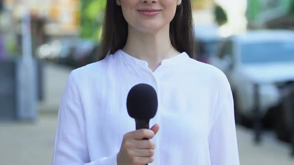 Female Correspondent Holding Microphone Outdoors, Interview Questions, Opinion