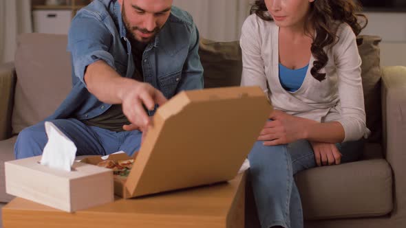 Happy Couple Eating Takeaway Pizza at Home