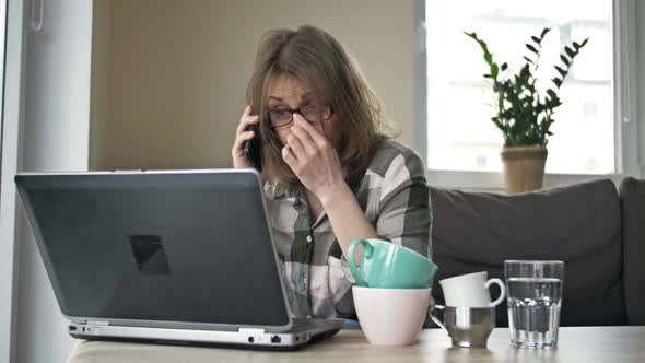 Tired Business Woman Working with Laptop at Home