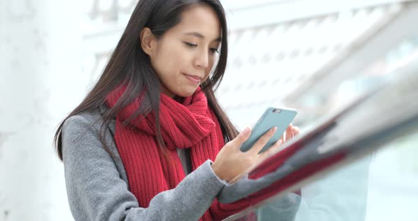 Woman look at mobile phone at outdoor