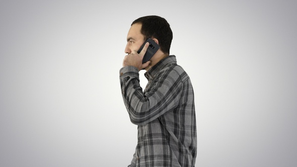 Cool Young Man with Beard Walking and Talking with Mobile