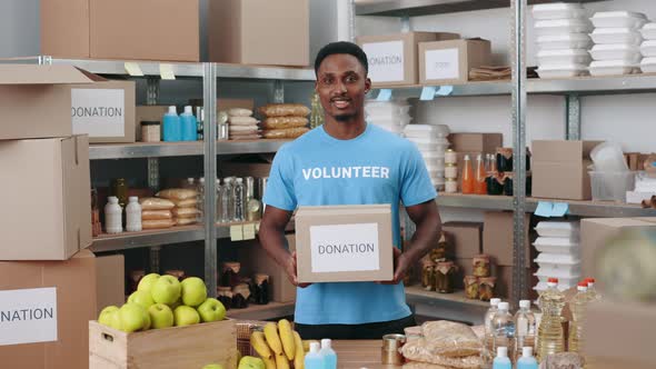 Handsome African American Man Holding Donation Box