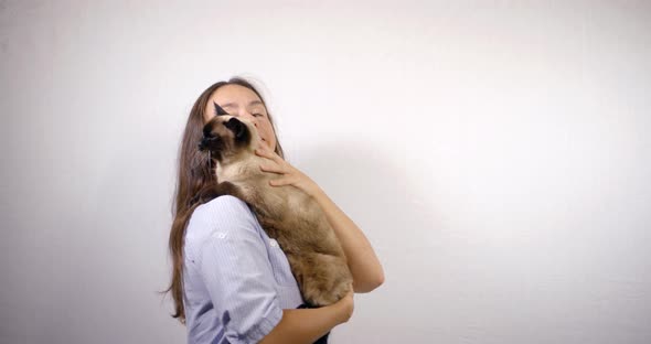 Pretty Lady with Long Loose Hair Holds Large Cat and Pets