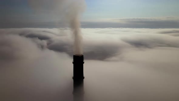 Coal Power Plant High Pipes Emitting Black Poisonous Smoke Moving Upwards Over White Fog Polluting