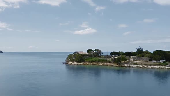 Air camera approaches the sea coast with Fort James ruins in St. John's, Antigua and Barbuda