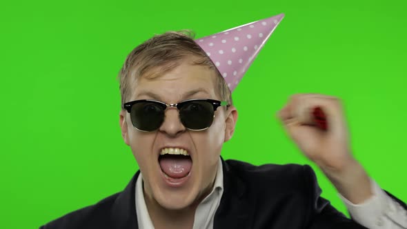 Drunk Young Businessman with Hangover in Festive Cap Drink Alcohol, Dance