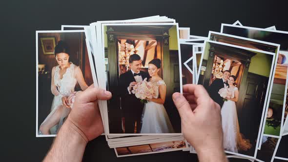 Hands Lay Out Wedding Photos