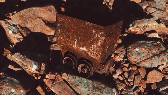 Abandoned Rusty Mine Cart on Rocks alt