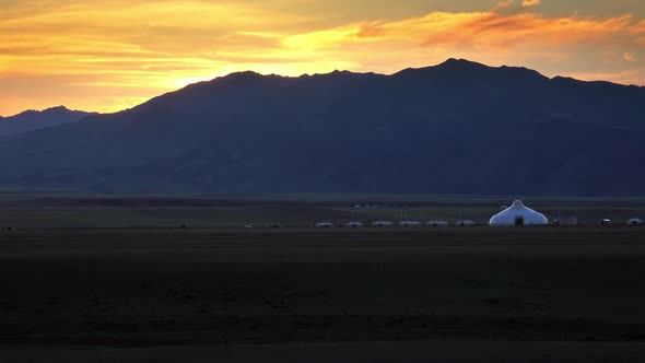 Mountains and Traditional Yurts After Sunset