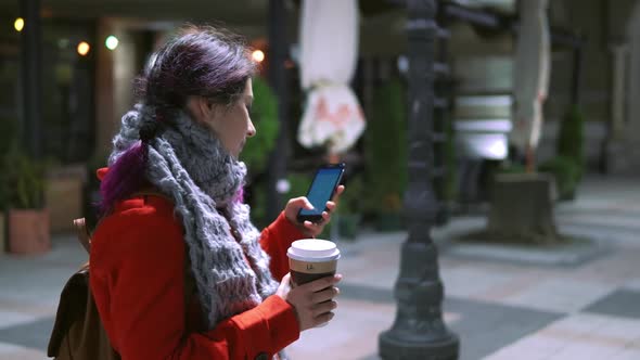 Smiling Woman Looking at Phone Screen