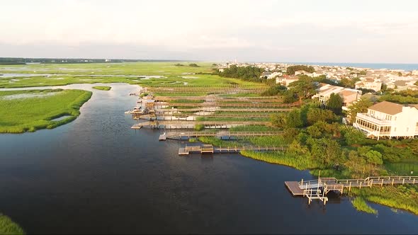 Ocean Isle Beach at sunset near the causeway and ocean flying over houses and piers