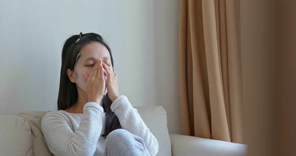 Woman apply face mask at home