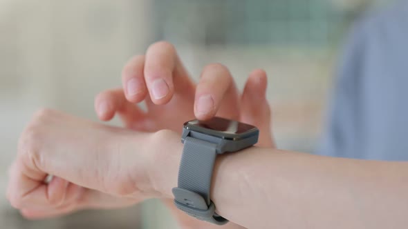 Close Up of Hands of Young Woman Using Smartwatch