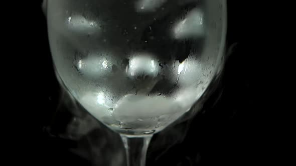 Dry Ice Bubbling in Glass at Black Background. Close Up. Slow Motion