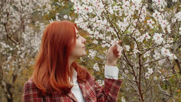 Happy Redhaired Girl Under Spring Flower Tree