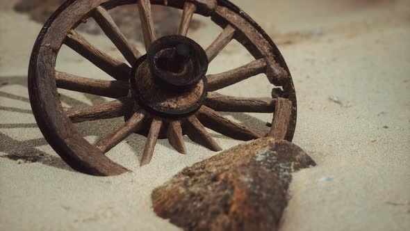 Large Wooden Wheel in the Sand