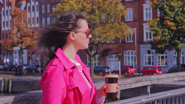 Attractive Woman in Sunglasses Drinking Coffee and Enjoying City View
