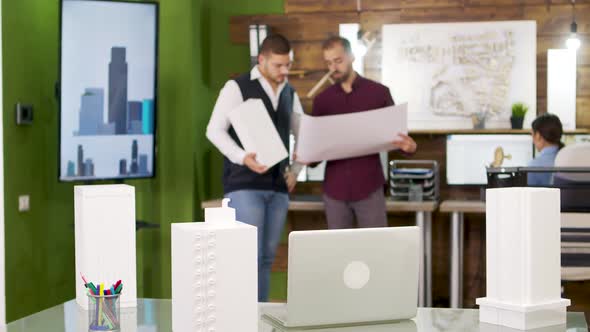 Slide View of Focus Transition with Architects Holding Blue Prints