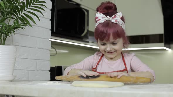 Cooking Pizza. Little Child in Apron Roll Dough with Rolling Pin at Home Kitchen