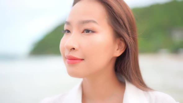 Asian woman enjoy around beautiful beach sea ocean