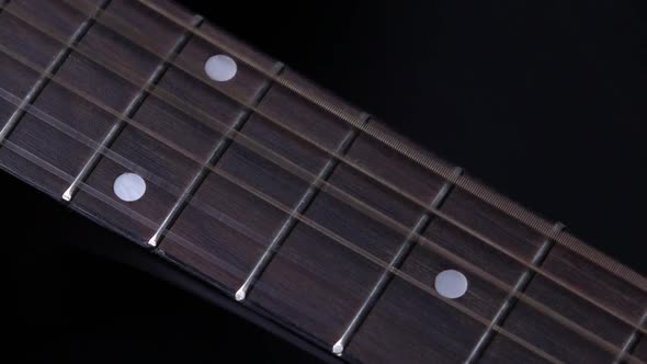 Strings of Acoustic Guitar, on Black, Close Up, Slow Motion