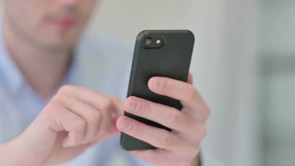 Close Up of Young Man Using Smartphone