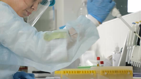 Back View of Female Scientist in Medical Uniform in Research Laboratory