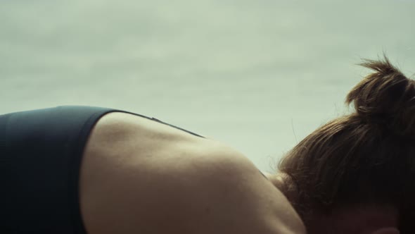 Woman Bend Back Practicing Yoga on Beach Close Up