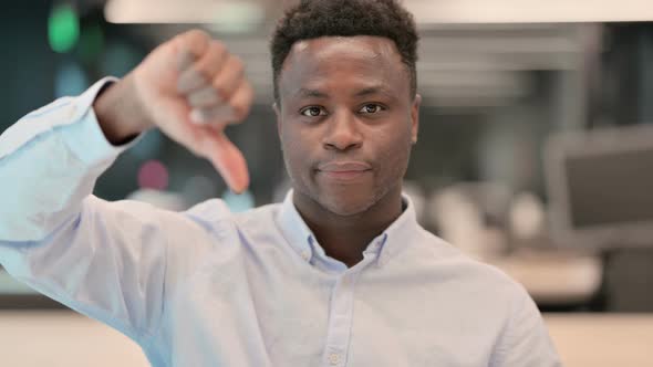 Portrait of Thumbs Down Gesture By African Businessman
