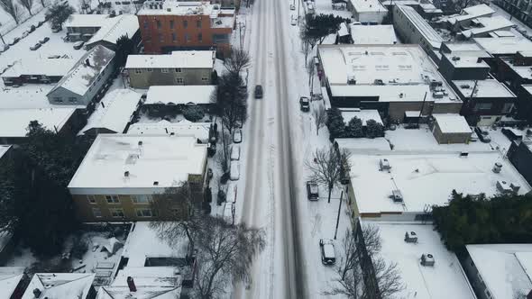 Cars Driving on Snowy Burnside Street During a Snowstorm in Portland Oregon