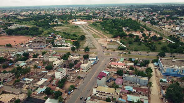 CInematic Circular Aerial View of african city neighborhood roads with Traffic, Lomé, West Africa