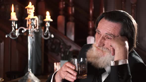 Senior Stylish Man Drinking Alcohol in Pub