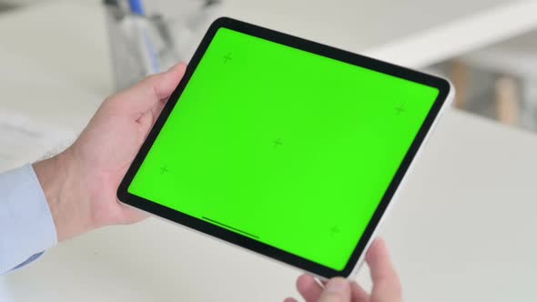 Middle Aged Man Using Tablet with Green Chroma Screen